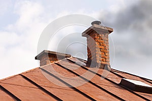 Brick chimney of old house with solid fuel stove