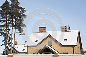 Brick chimneys heated the cottage against a blue sky, the snow-covered roof of the cottage