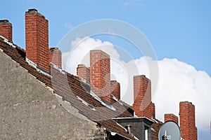 brick chimneys on the roof of an old building