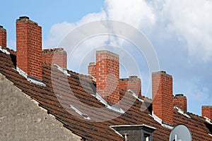 brick chimneys on the roof of an old building