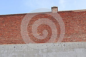 Brick and concrete wall with smoke stack