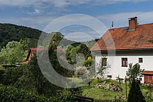 Brick country house with red roof in summer