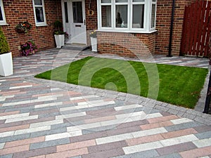 Brick driveway in grassy yard