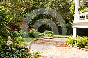 Brick Driveway Past Landscaped Garden