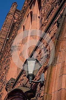 The brick facade and entrance lamps of an old historic church wi