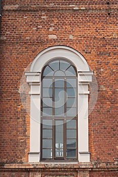 Brick facade of a house with a large window