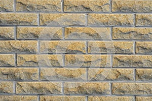 Brick facade tiles, chipped yellow bricks, texture of the facade
