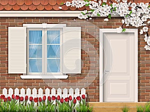 Brick facade with window fence tulips