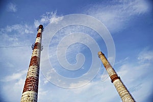 Brick factory pipes on a background of blue sky