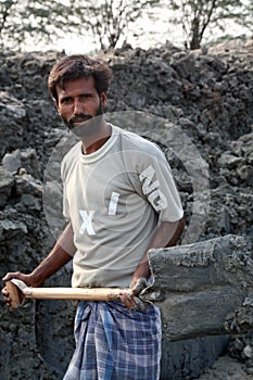 Brick field. Laborers are carrying deposited soil for making raw brick in Sarberia, India