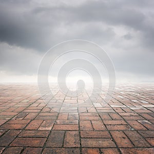 Brick floor and rainclouds for background