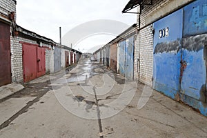 Brick garages with metal gates of garage cooperative in Russia photo