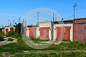 Brick garages with red metal gates of garage cooperative