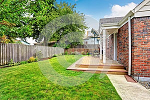 Brick house exterior with walkout wooden deck