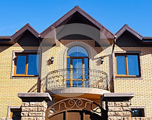 Brick house with forgery balcony, facade view