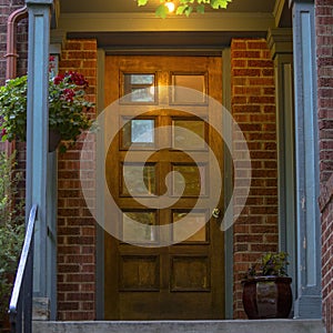 Brick house with glass paned brown wood front door