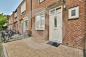 a brick house with a sidewalk and a white door