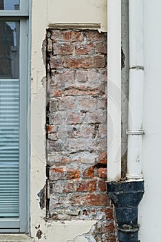 Brick House wall with flaking plaster
