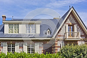 Brick house with white shutters in Etretat