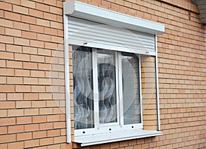 Brick house window with rolling shutter for home protection