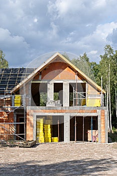 Brick house with wooden rooftop and modern attic space with large mansard windows