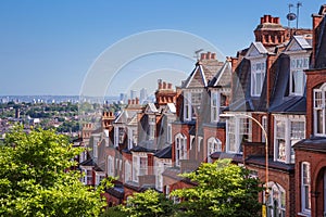 Brick houses of Muswell Hill and panorama of London with Canary Wharf, London, UK