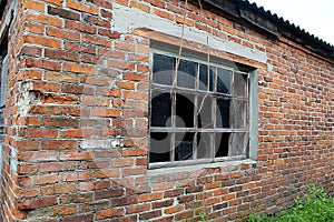 abandoned brick building with an old large window