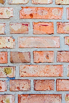 Brick orange red wall. Vertical pattern of building bricks with layers of cement