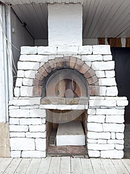 A brick oven with a stone chimney
