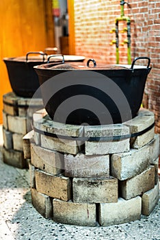 Brick ovens with old pots in the kitchen