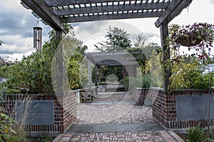 The brick path of a well manicured sensory garden on a cloudy day.
