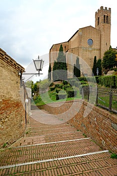 Brick paved pedestrian street. Ancient street of the city of Siena in Tuscany.