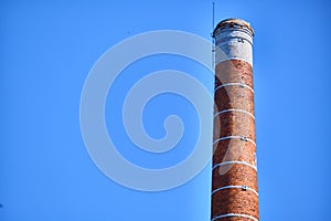 brick pipe against the blue sky. general plan color