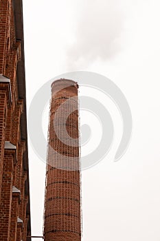 Brick pipe in an old factory vertically against the sky c copy space