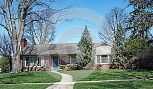 Brick Ranch Home Nestled in Trees with Curved Walk