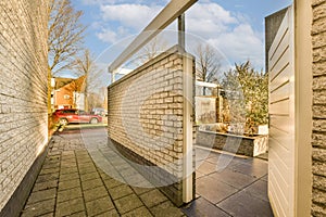 a brick retaining wall with a gate on a driveway