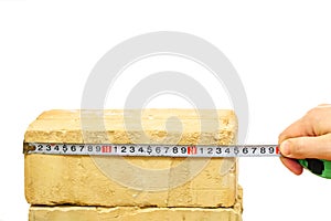 Brick and ruler isolated on white photo