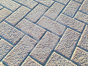 A brick sidewalk with a checkered pattern