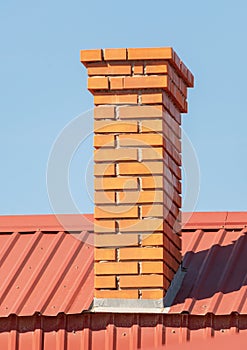 Brick smokestack on background sky