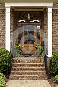 Brick staircase leading up to a brown front door