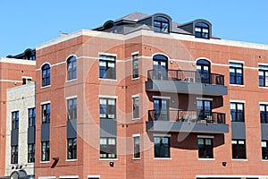 Brick and stone apartment building with outdoor patios