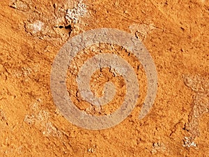 Brick or stone close-up. Texture or background. Bright red, brown, orange, beige colors. Dust, small pebbles, sand, soil and moss