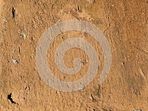 Brick or stone close-up. Texture or background. Bright red, brown, orange, beige colors. Dust, small pebbles, sand, soil and moss