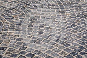 Brick stone street pavement close up background. Empty dark stone pavement on old town ancient street