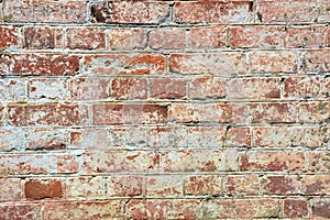 Brick texture close-up. Brick wall made of red bricks. Old masonry. Collapsed wall of a house