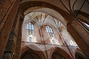Brick vault with windows, arches and pillars inside the St. Georgen Church in the old town of Wismar, famous tourist attraction