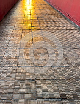 A brick walkway with a checkered pattern