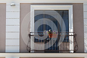 Brick wall with brick filled window with flowers