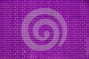 Brick wall is bright purple colored, texture of stone blocks, background of bricks.