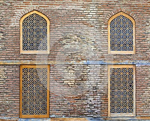 Brick wall of building and windows in arabic style. Close up